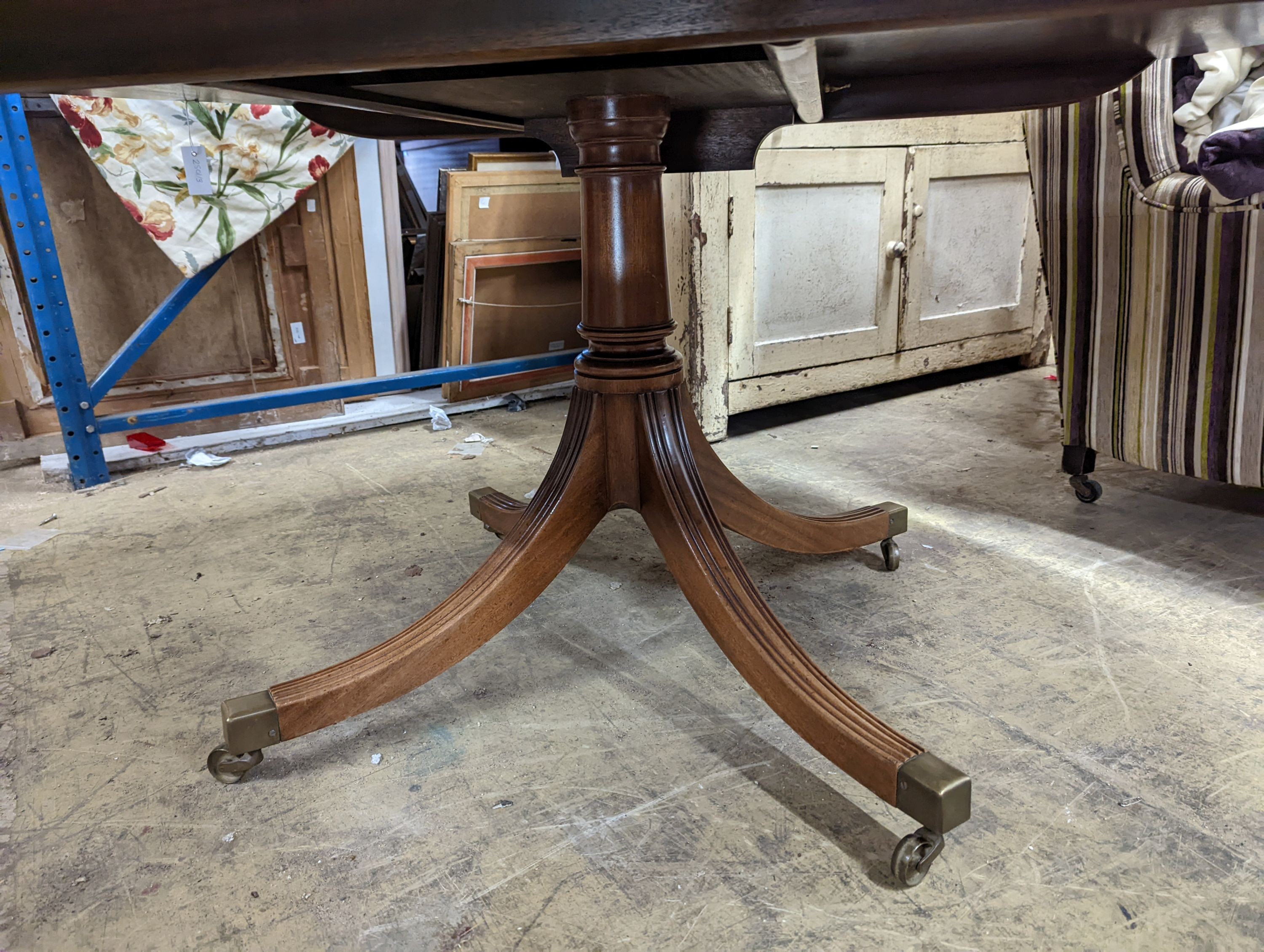 Attributed to William Tillman, a reproduction George III style banded mahogany circular pedestal tilt top dining table, diameter 160cm, height 72cm